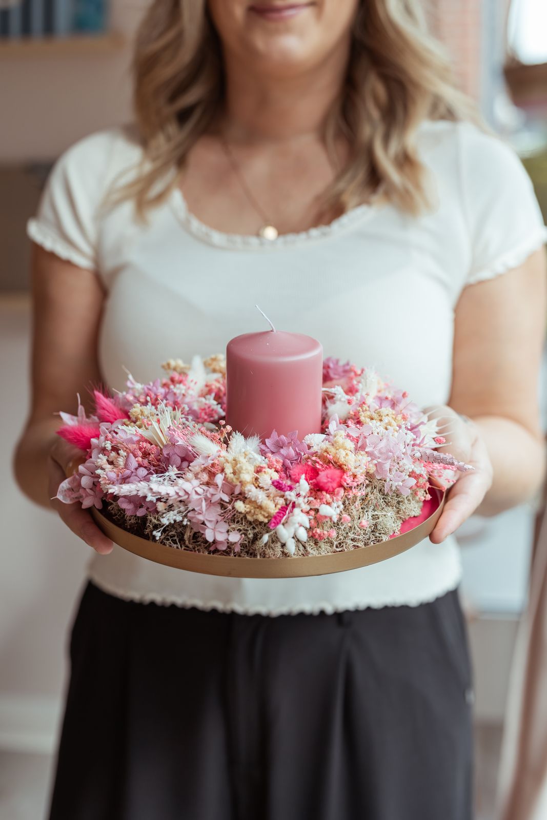 Kranz aus Trockenblumen und Moos mit rosa Kerze